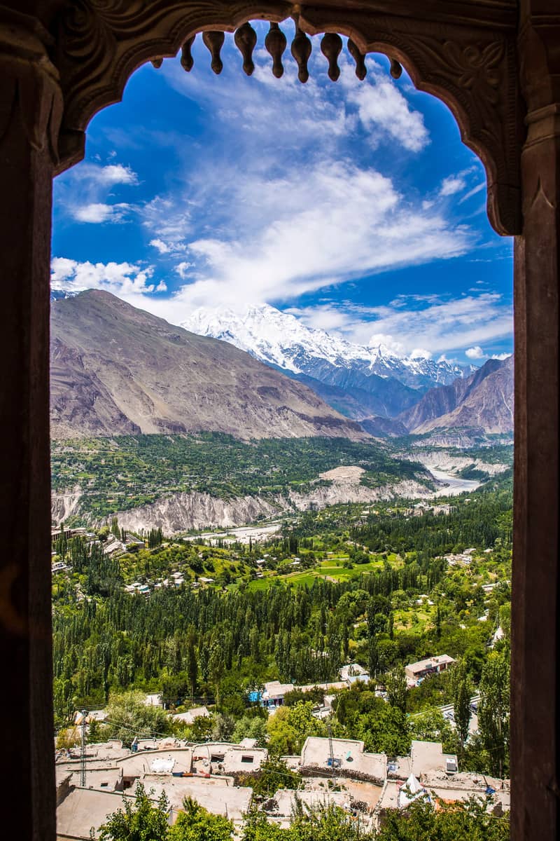 A carved wooden window at Altit Fort, looking out over the Hunza valley